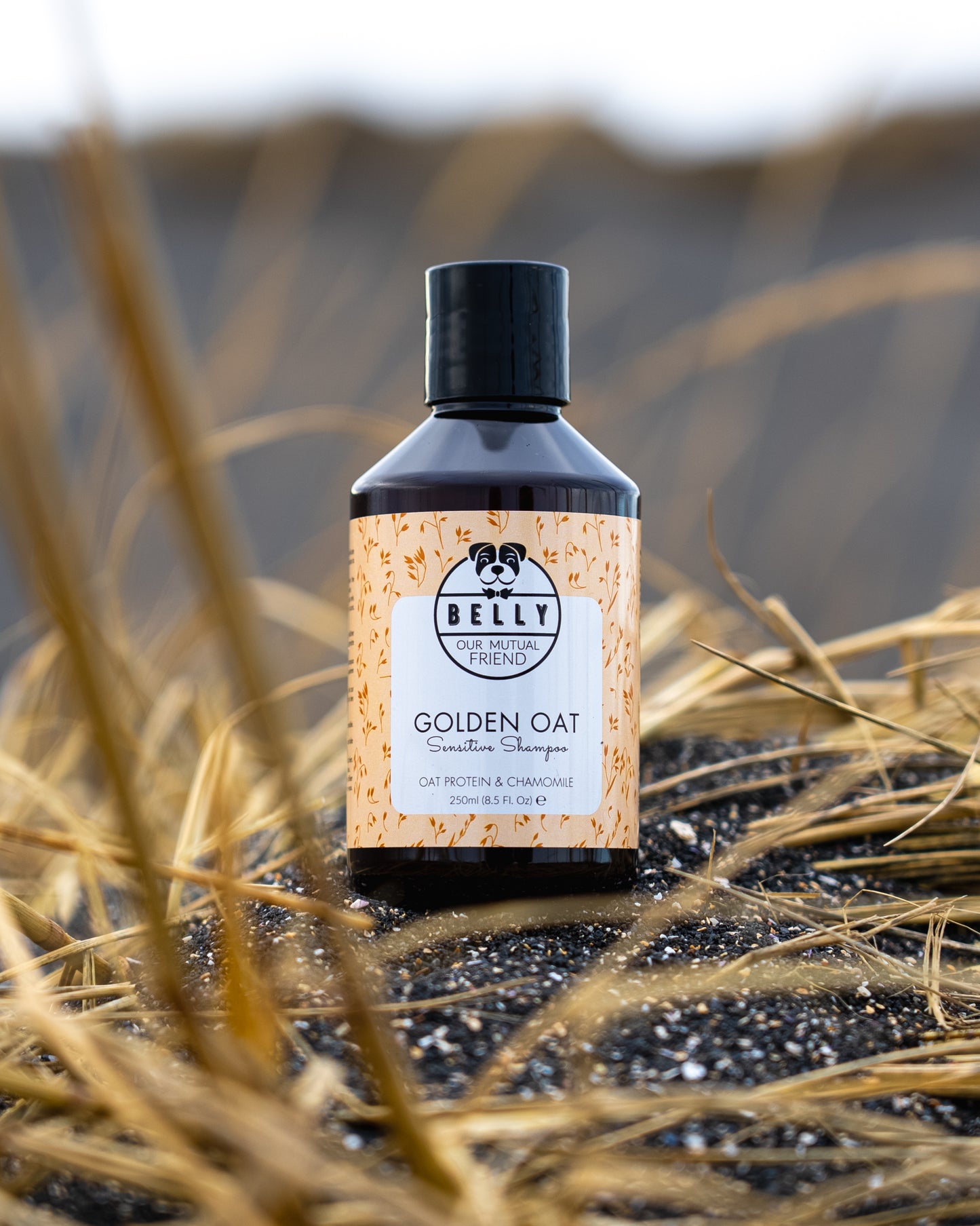 A bottle of Oatmeal Shampoo placed on a grassy surface.